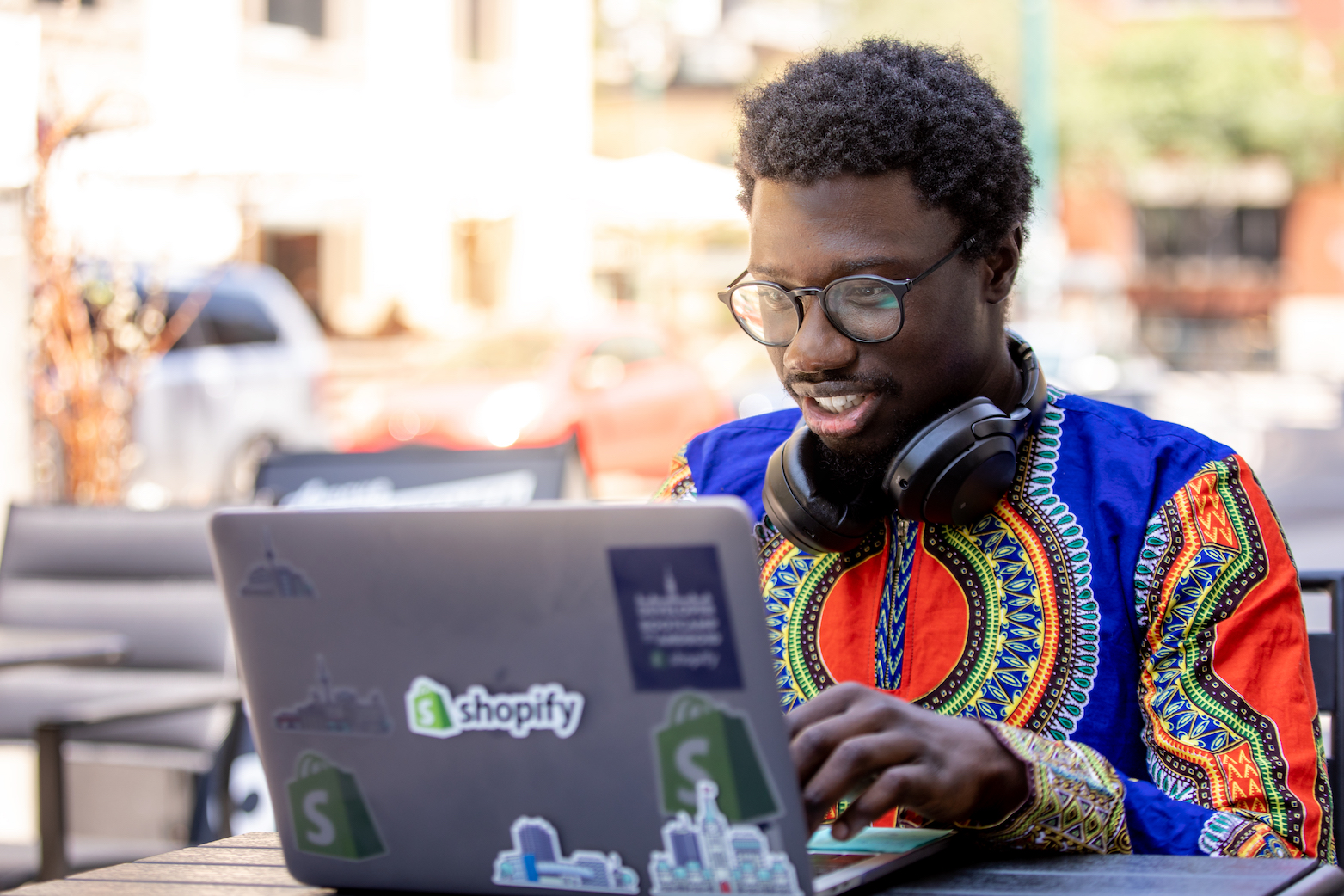 Person with laptop with shopify sticker